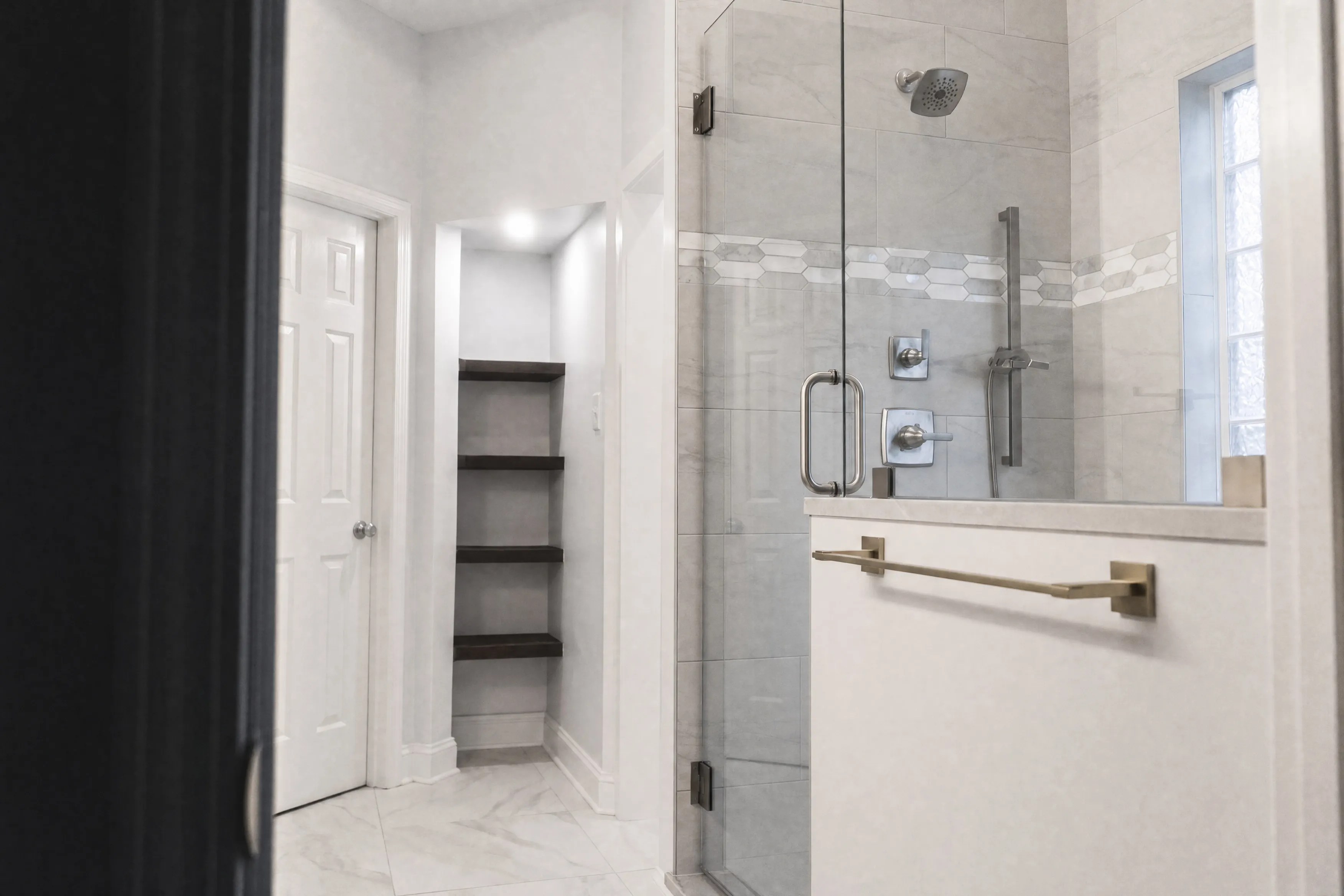 Walk-in shower with mosaic tile border and built-in bench