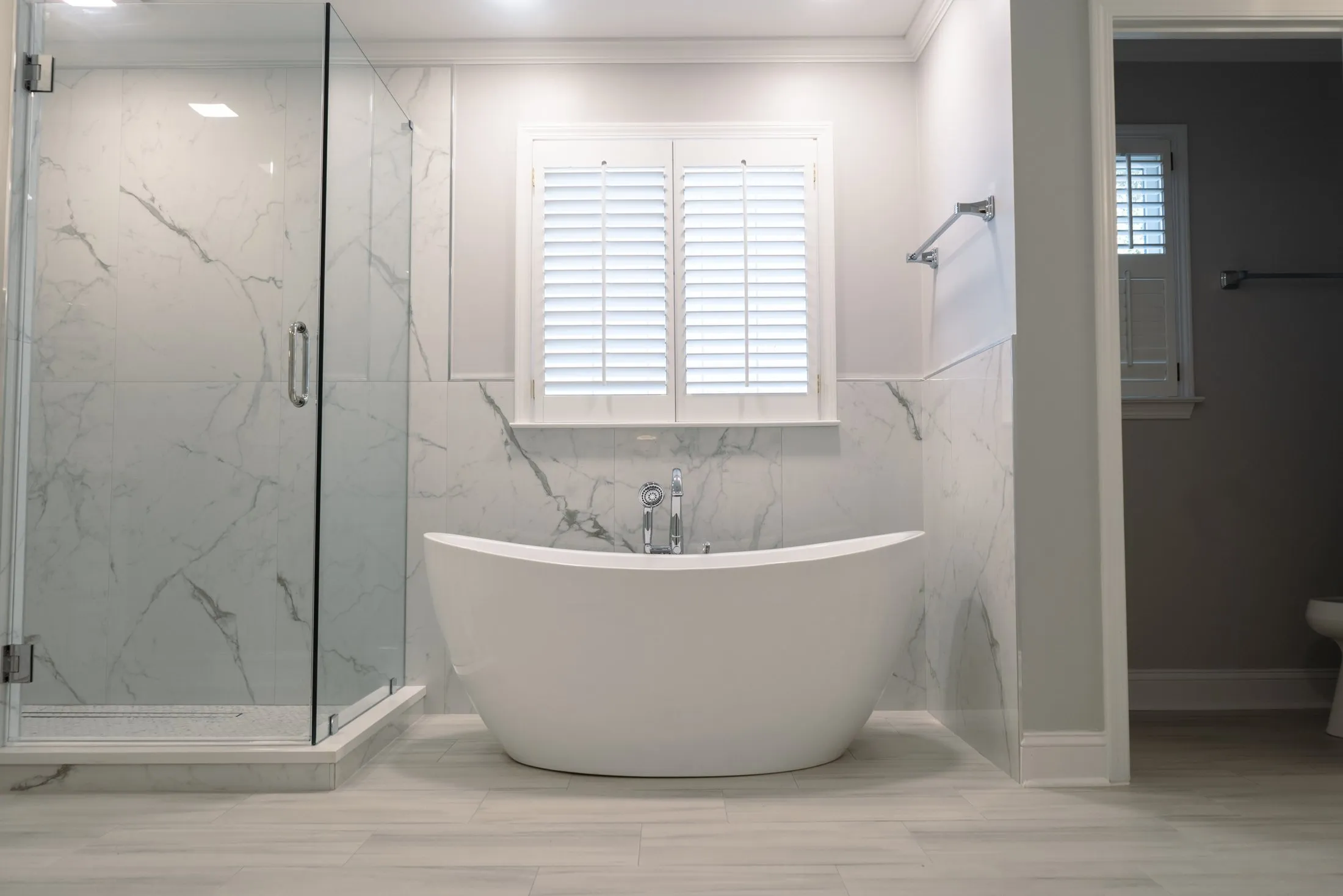 Master bathroom in Peachtree City with a freestanding tub and marble-look porcelain