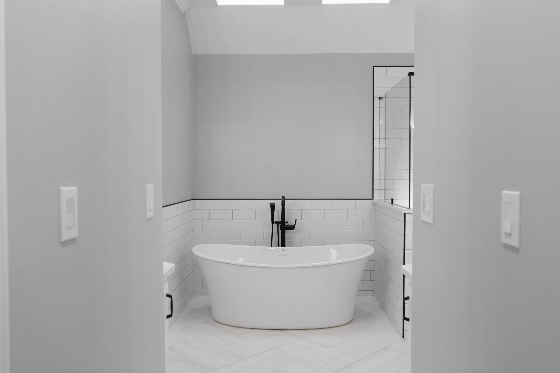 Freestanding tub in a white subway tile master bathroom