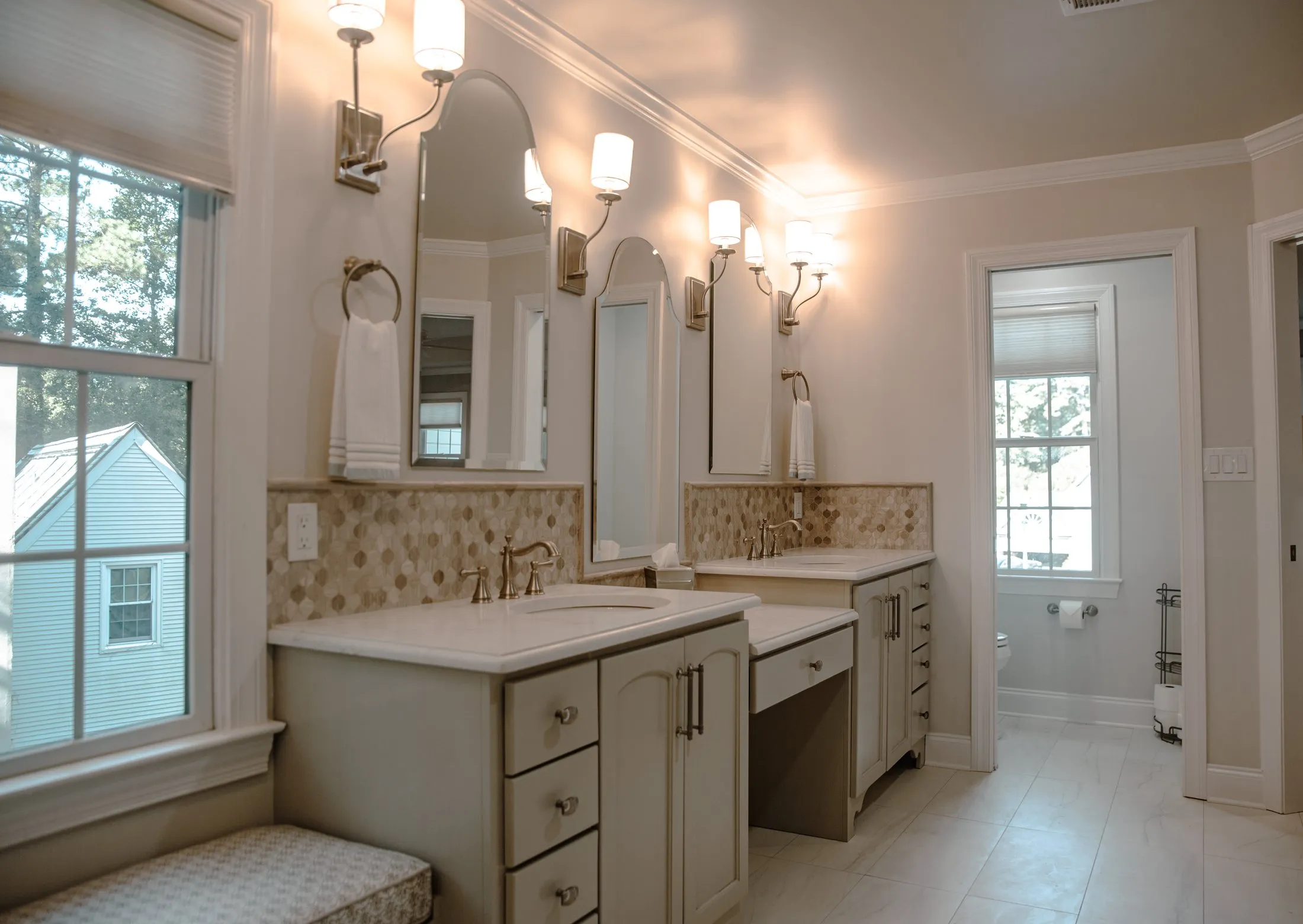 Twin vanities and a make-up station in a traditional master bathroom