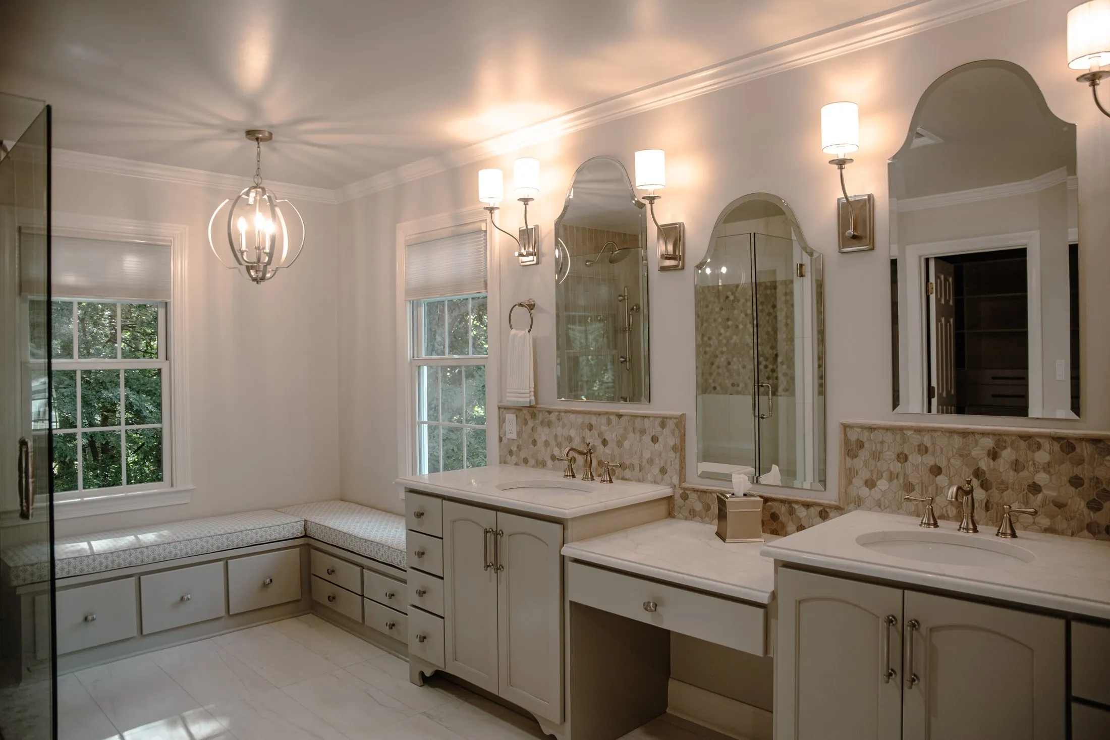 Large traditional master bathroom with twin vanities and a mosaic backsplash