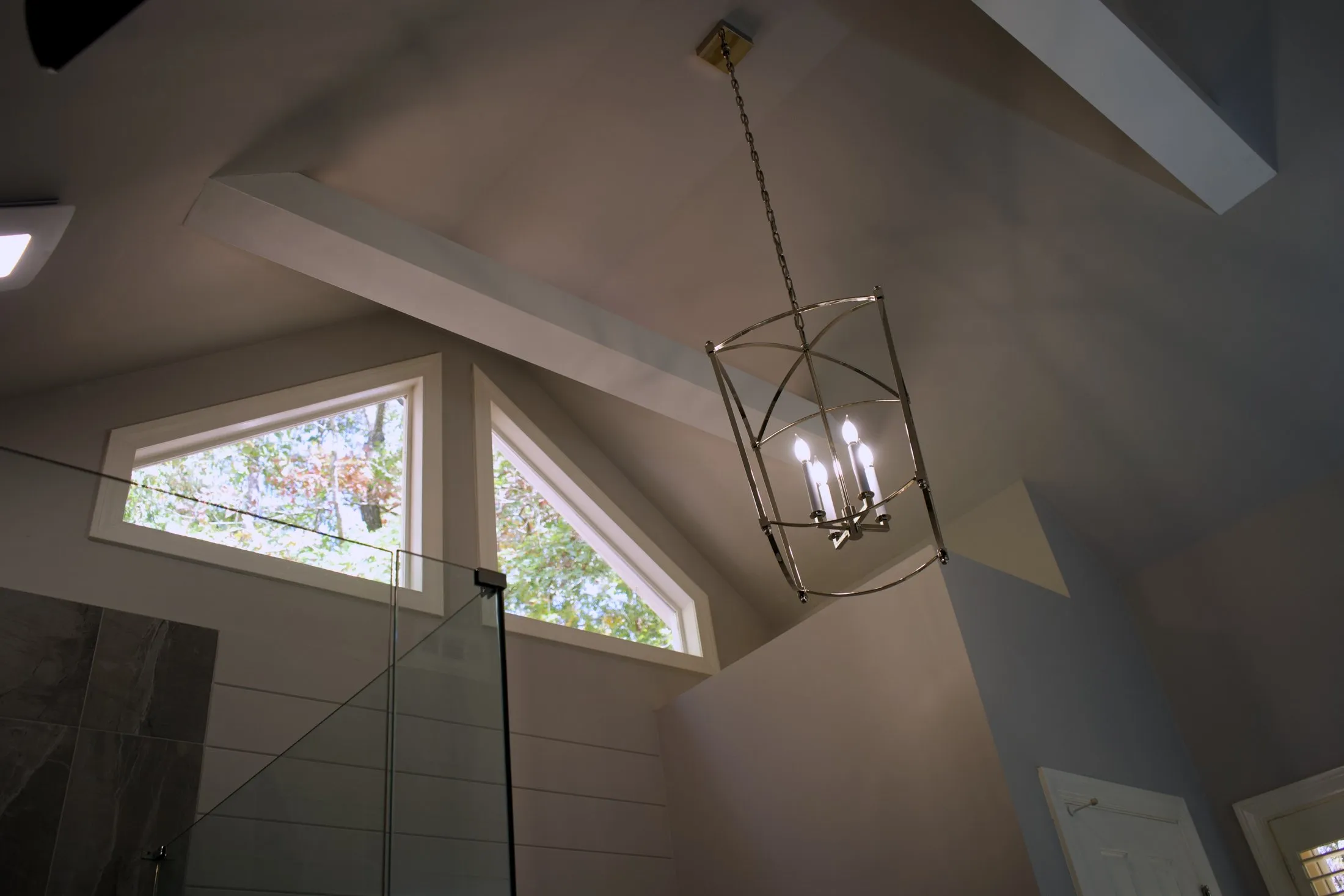 Vaulted master bathroom ceiling with a lantern pendant