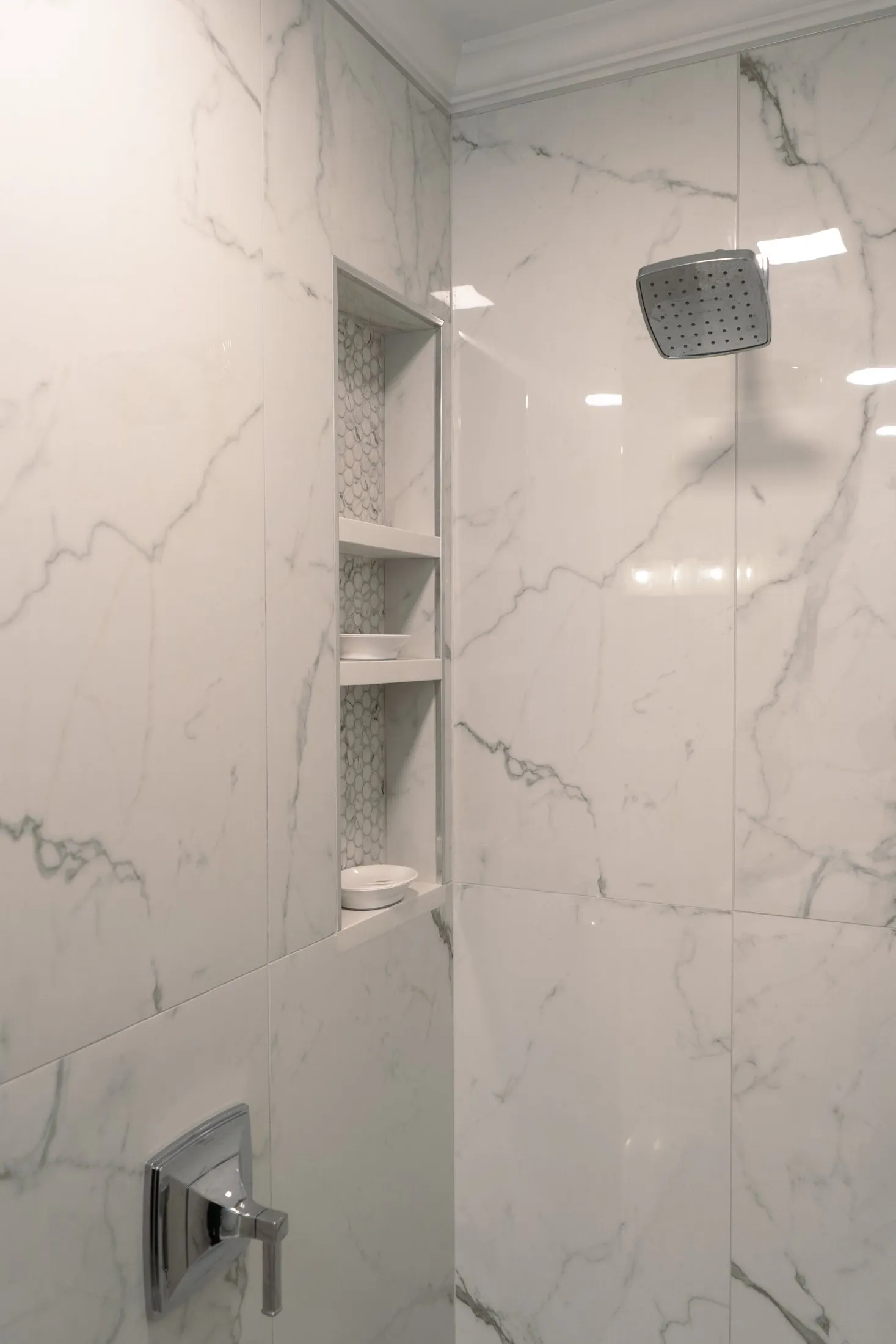 Marble-look shower wall with built-in niche shelving