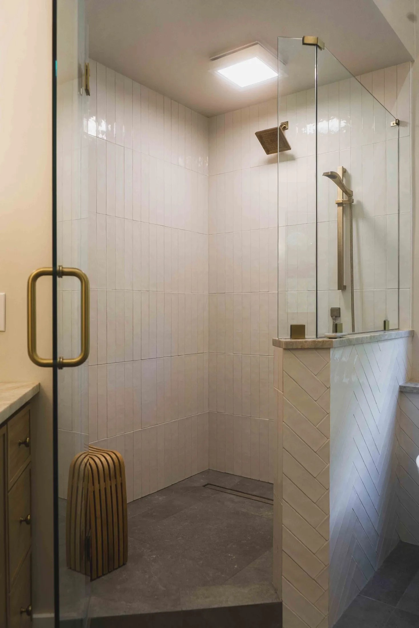 Glass shower enclosure with brass hardware