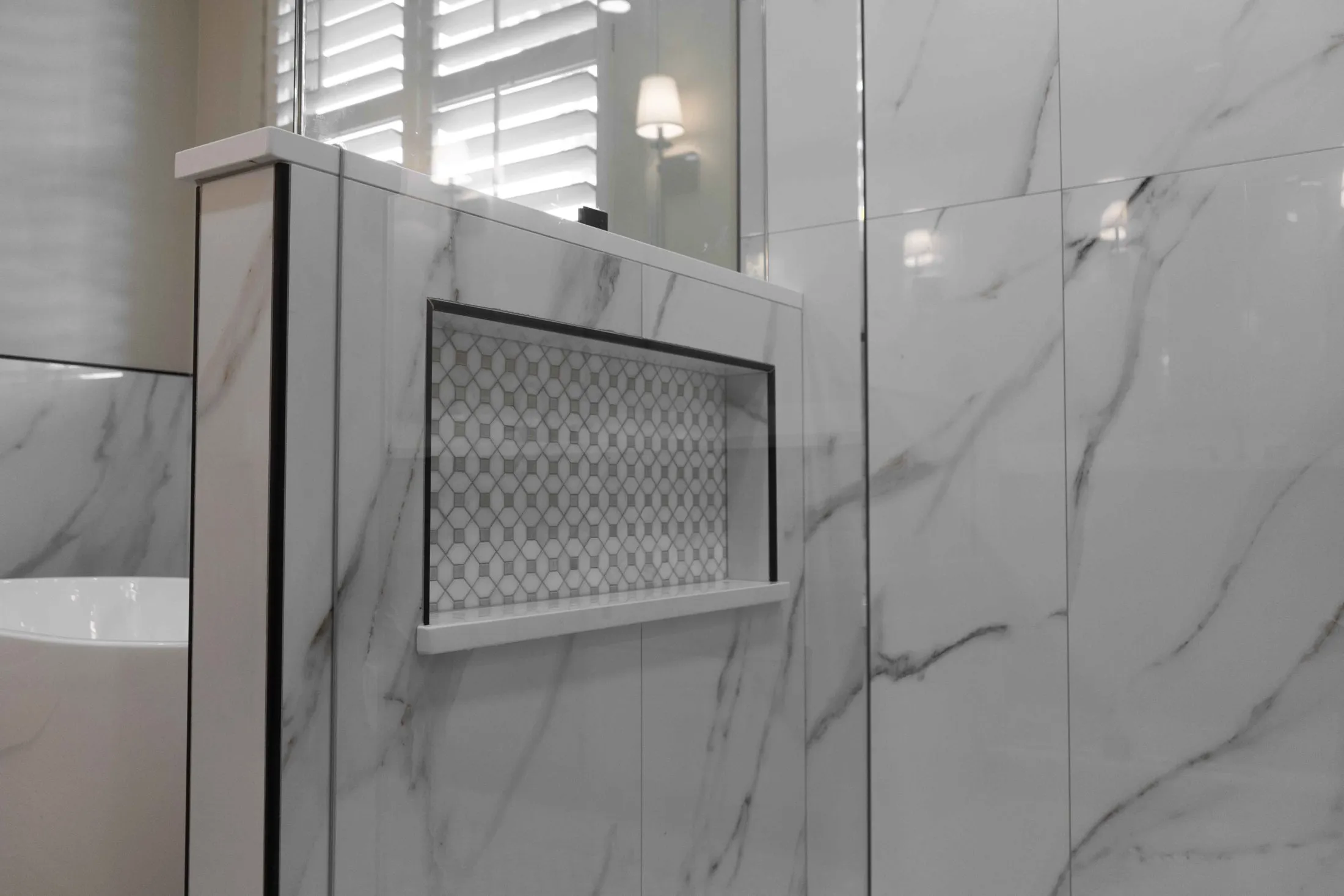 Shower niche set into a marble-look tile wall