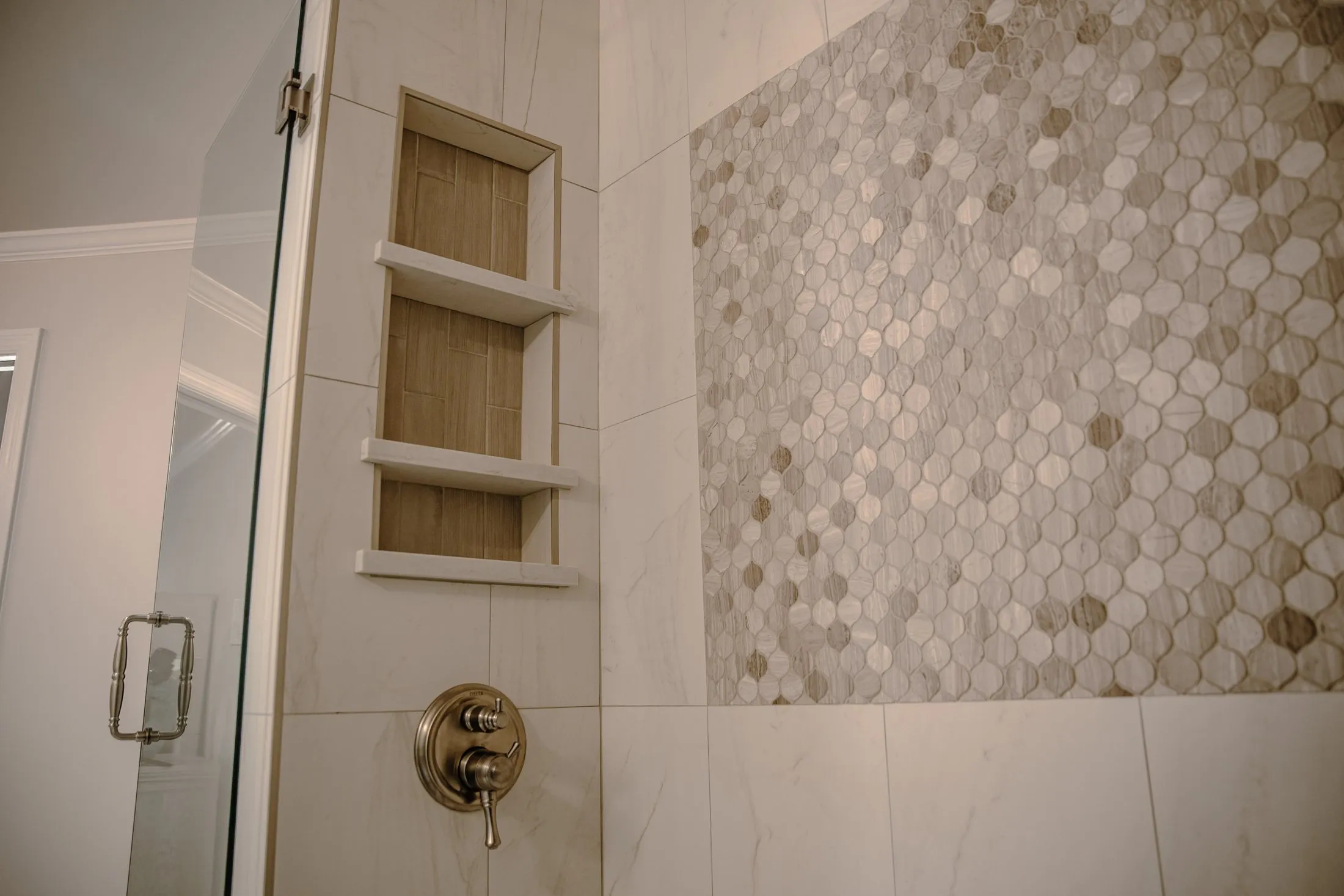 Shower niche beside a hexagon mosaic feature wall