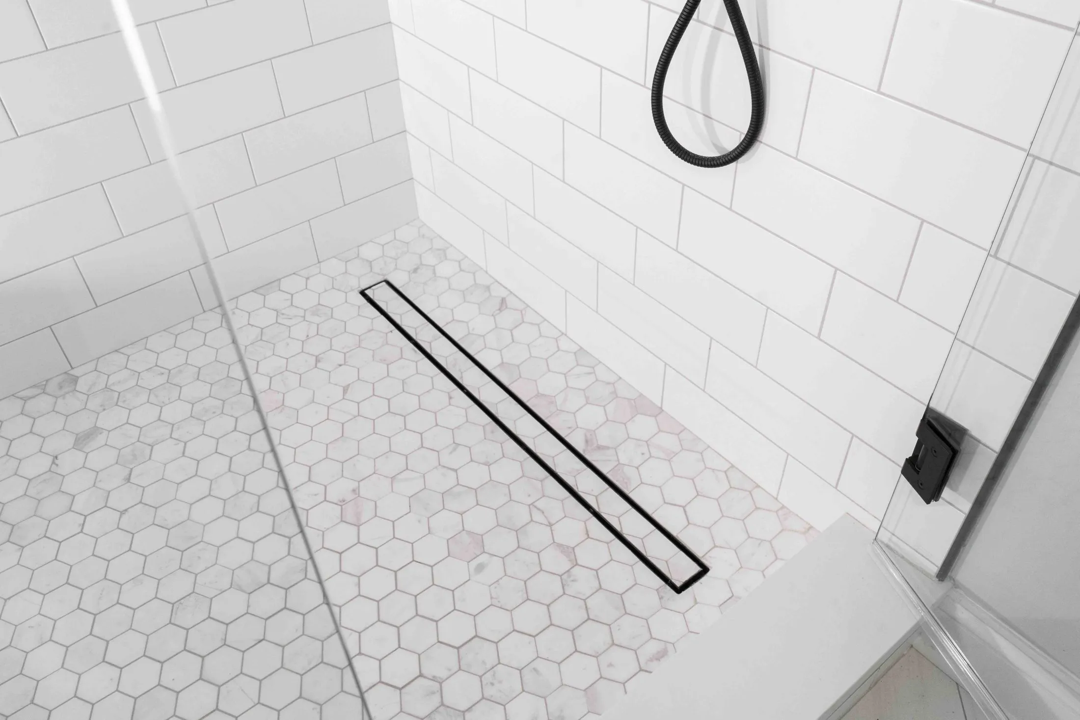 Hexagon mosaic shower floor with a linear drain