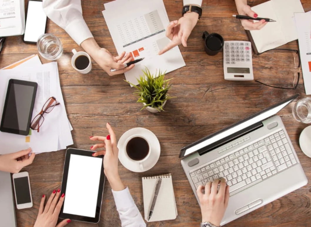 Business meeting with computers and coffee