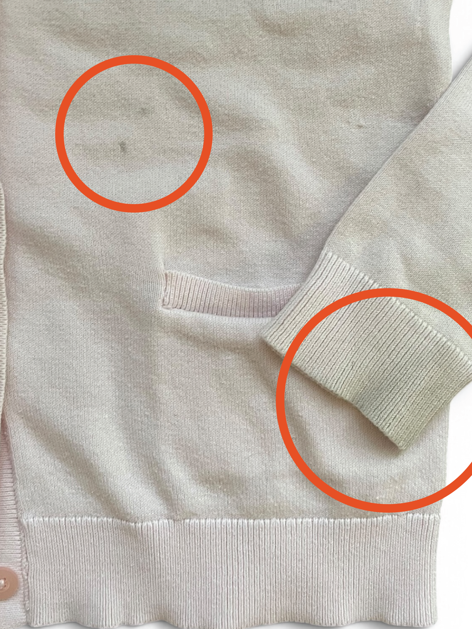 Cream cardigan with grey, dirty cuffs, circled