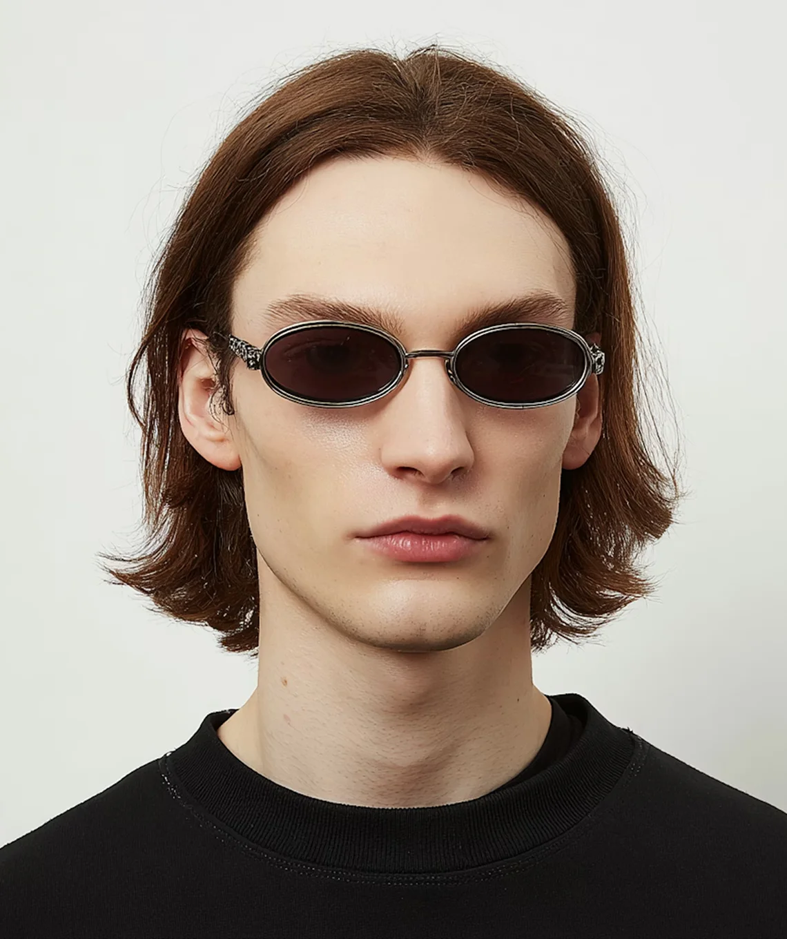 A man wearing a black shirt and sunglasses.