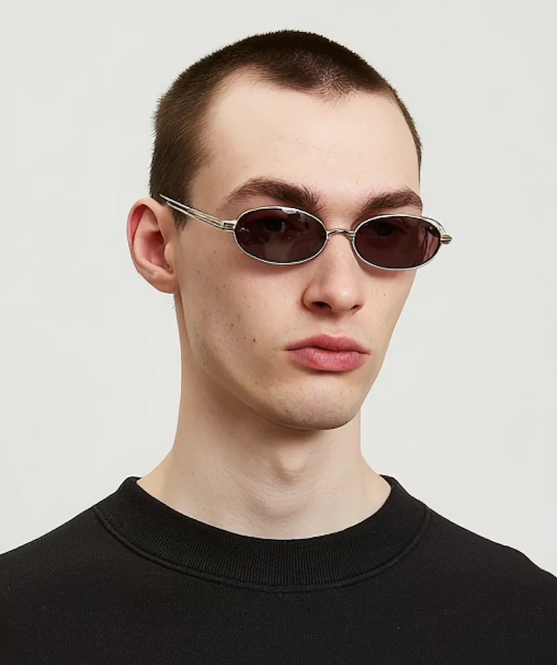A young man wearing a pair of sunglasses.