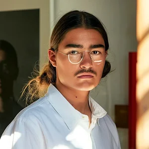 A man wearing glasses and a white shirt.