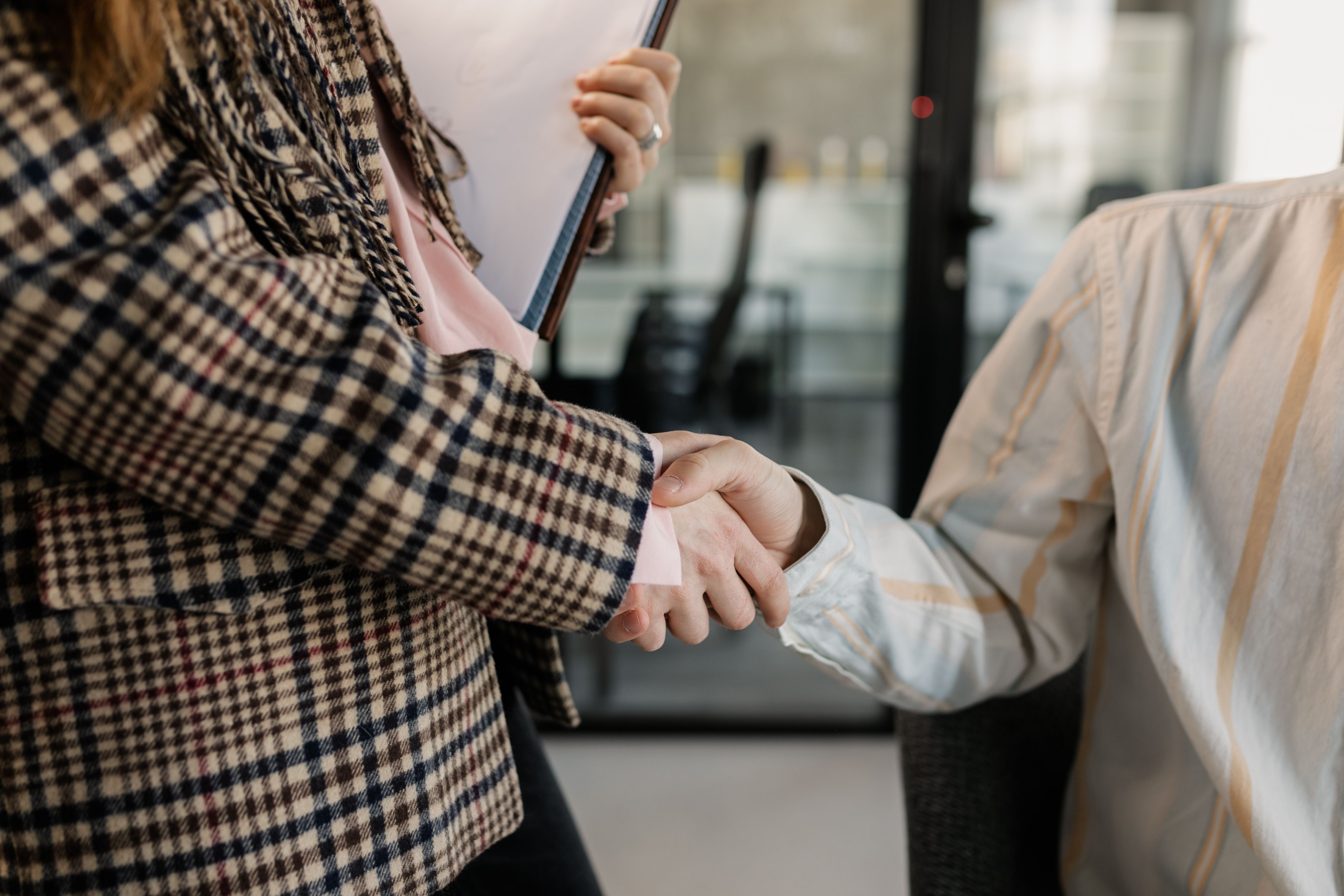 Two women shaking hands after exchanging views.