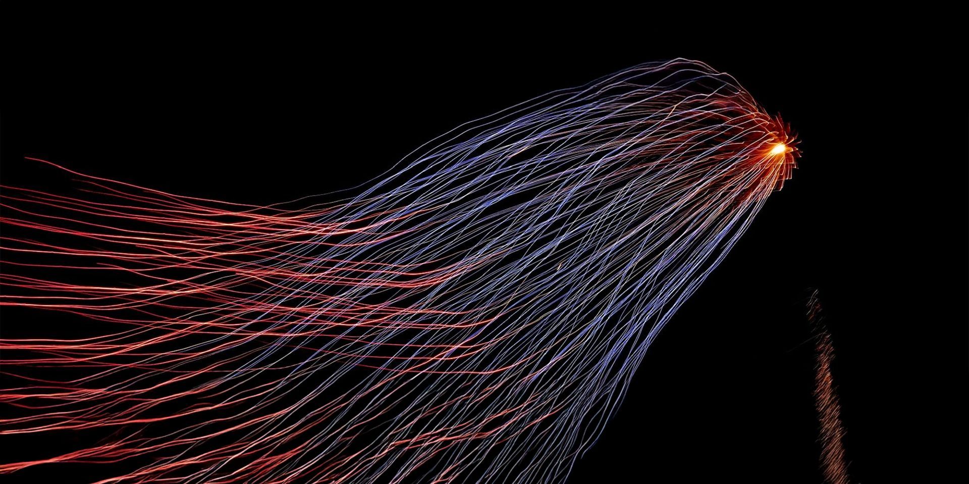 A fast laser or light beam against a dark background, creating a dynamic motion effect.