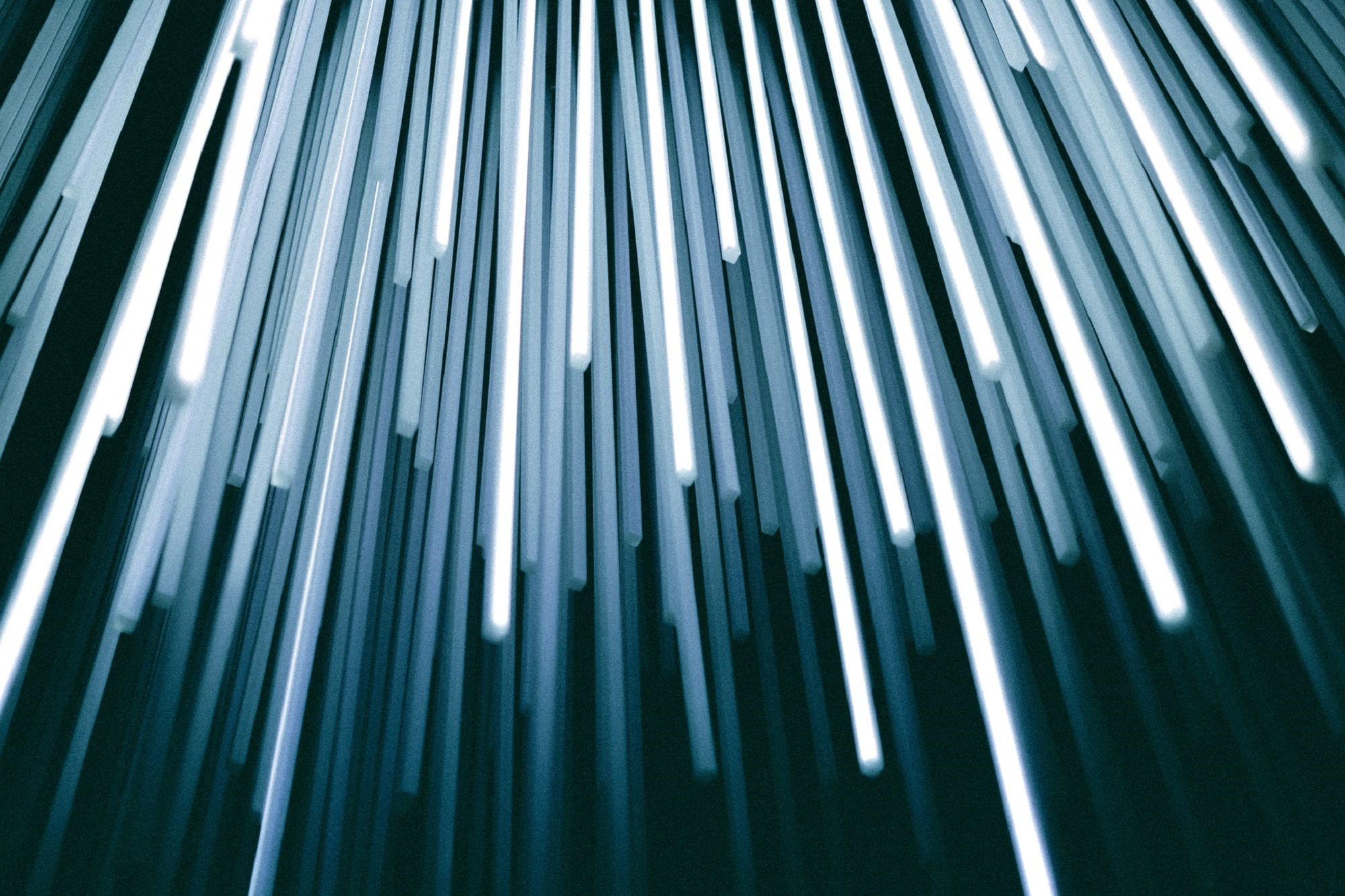 Light blue rays of light pointing downward, resembling fibre optics or lasers.