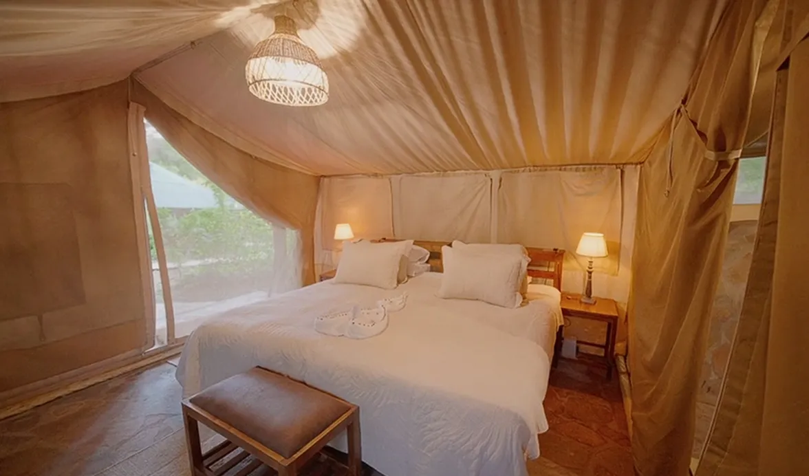 Luxury glamping tent bedroom at an Unlimited Life retreat destination
