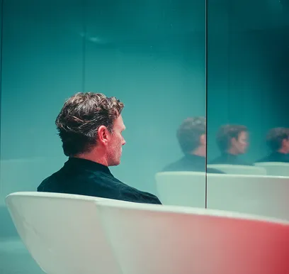Person in a sensory deprivation float tank for immersive neurofeedback therapy