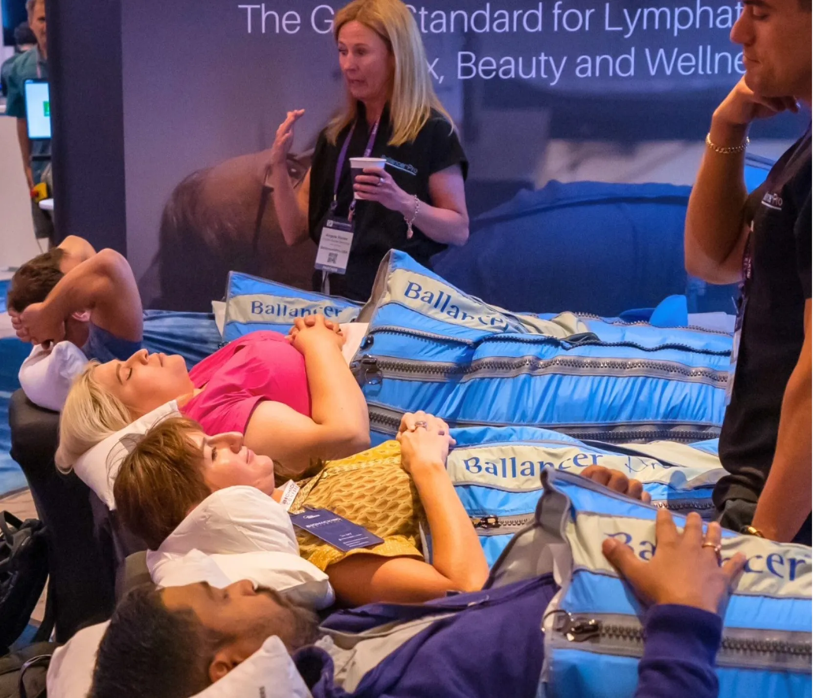 Attendees experiencing Ballancer Pro lymphatic drainage therapy suits at the Biohacking Conference