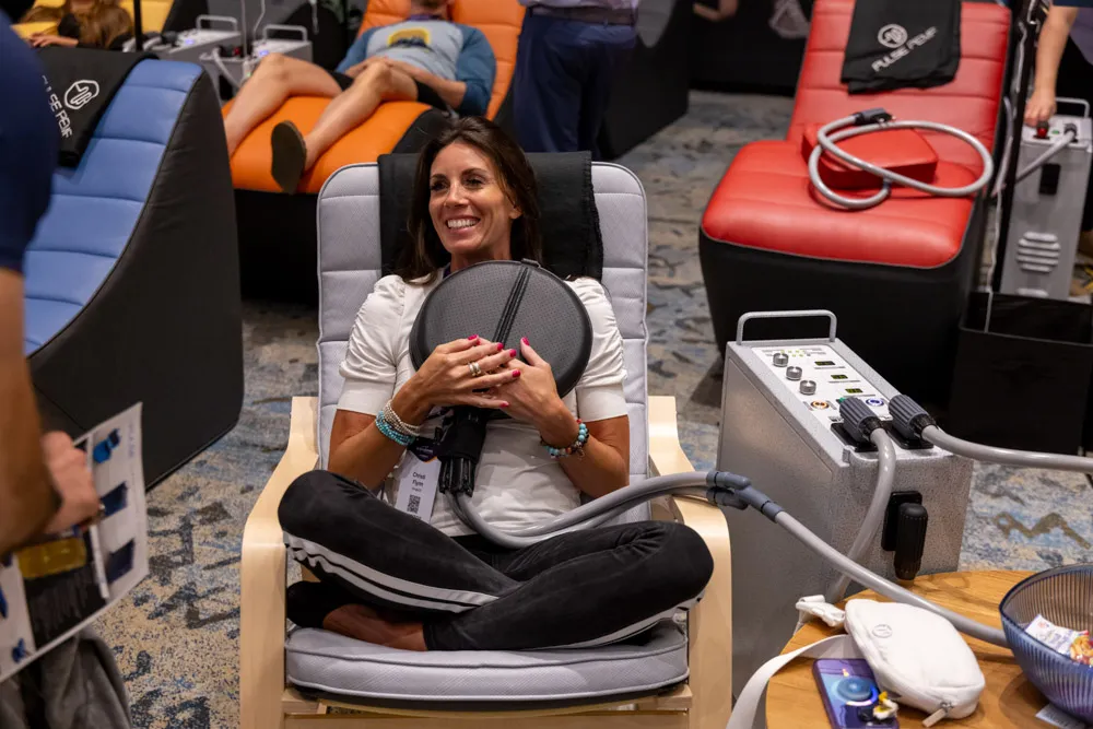 Woman receiving a biohacking therapy session at the conference