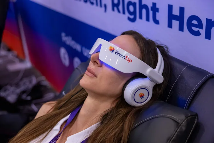 Woman wearing a white neurofeedback headset at the Biohacking Conference