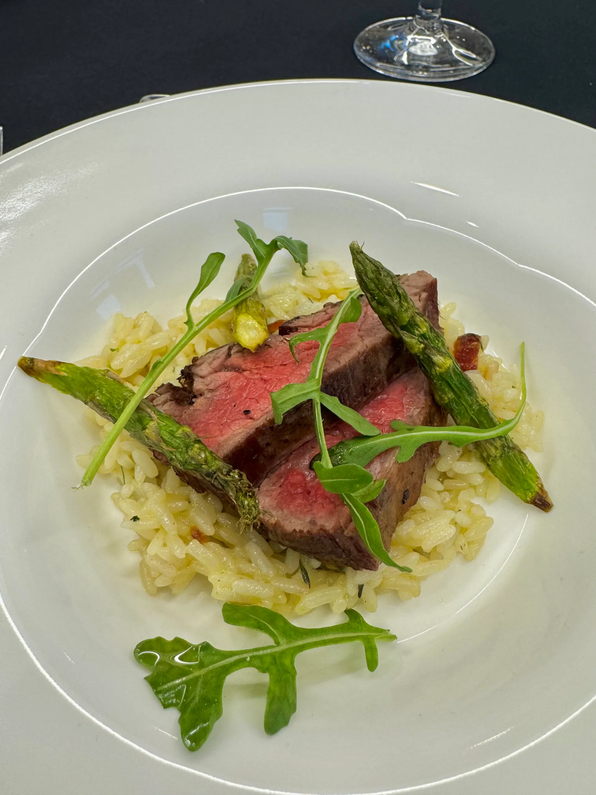 Grilled steak slices with green beans and microgreens salad