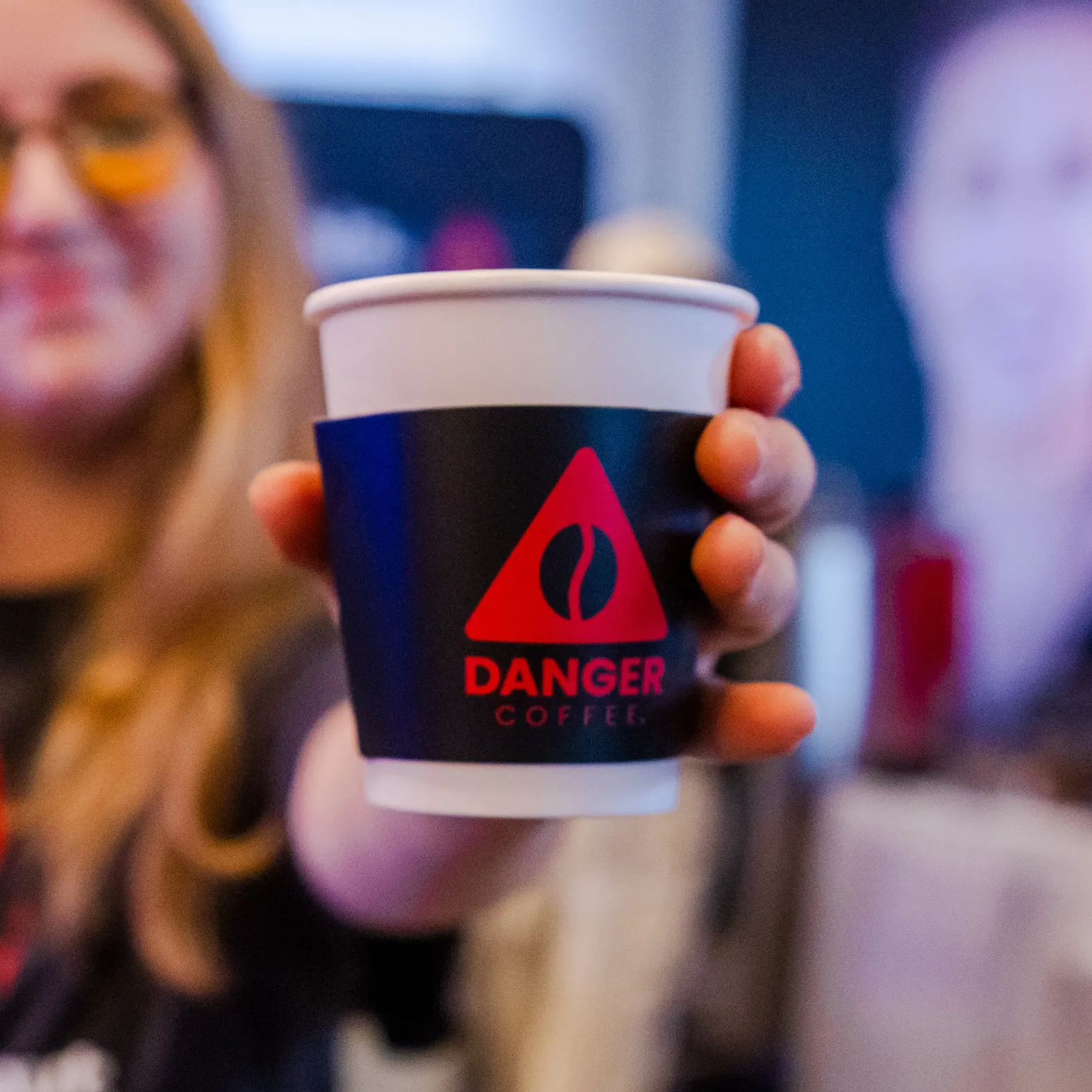 Person holding a branded Bulletproof coffee cup
