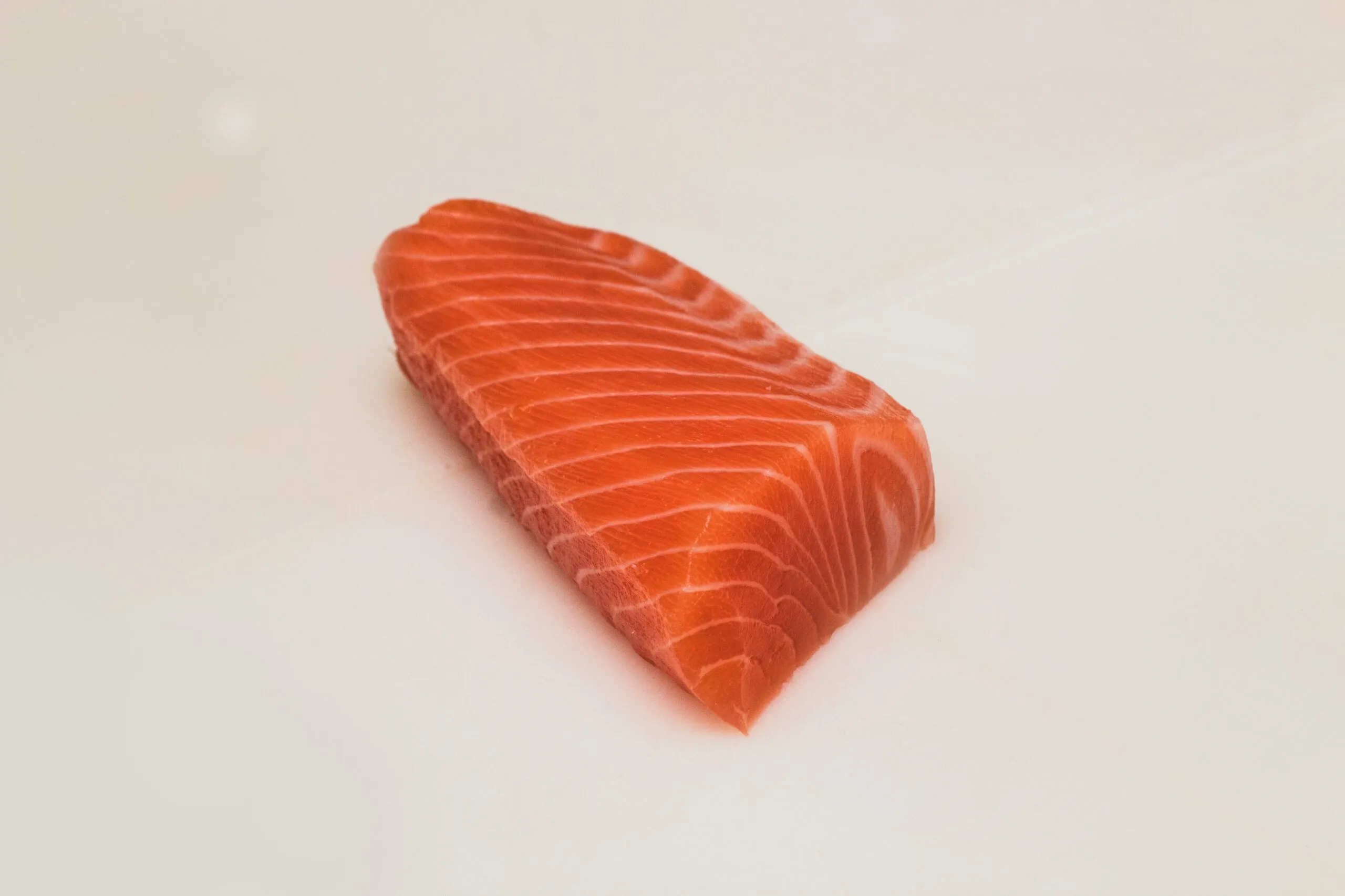 Fresh raw salmon fillet on a white surface