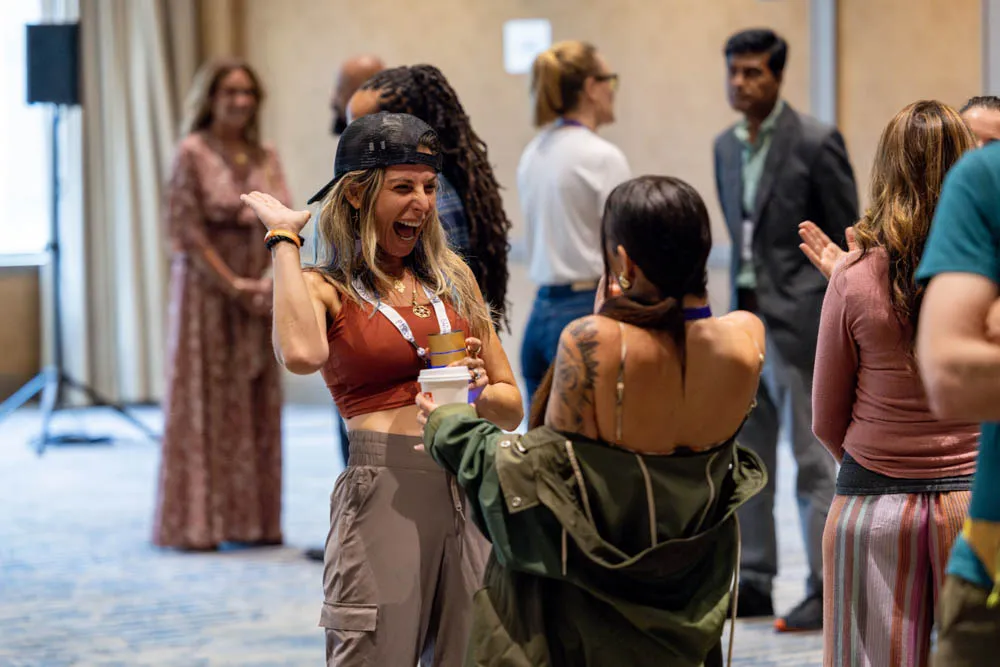 Excited conference attendees connecting and networking at the Biohacking Conference
