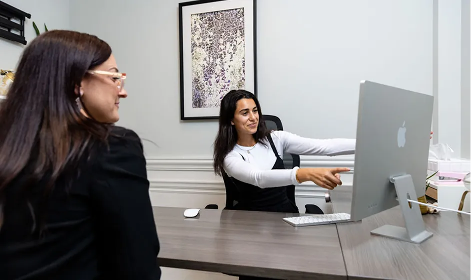 Medical coordinator consulting with a patient at a clinic desk