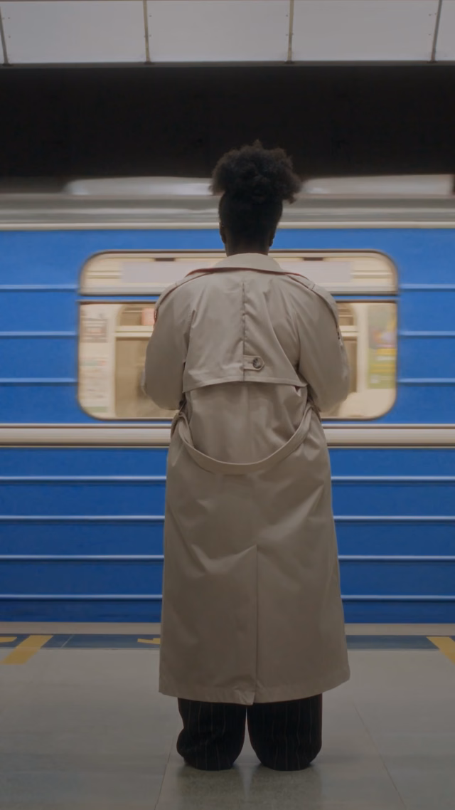 Person standing on a train platform in a video about lifestyle