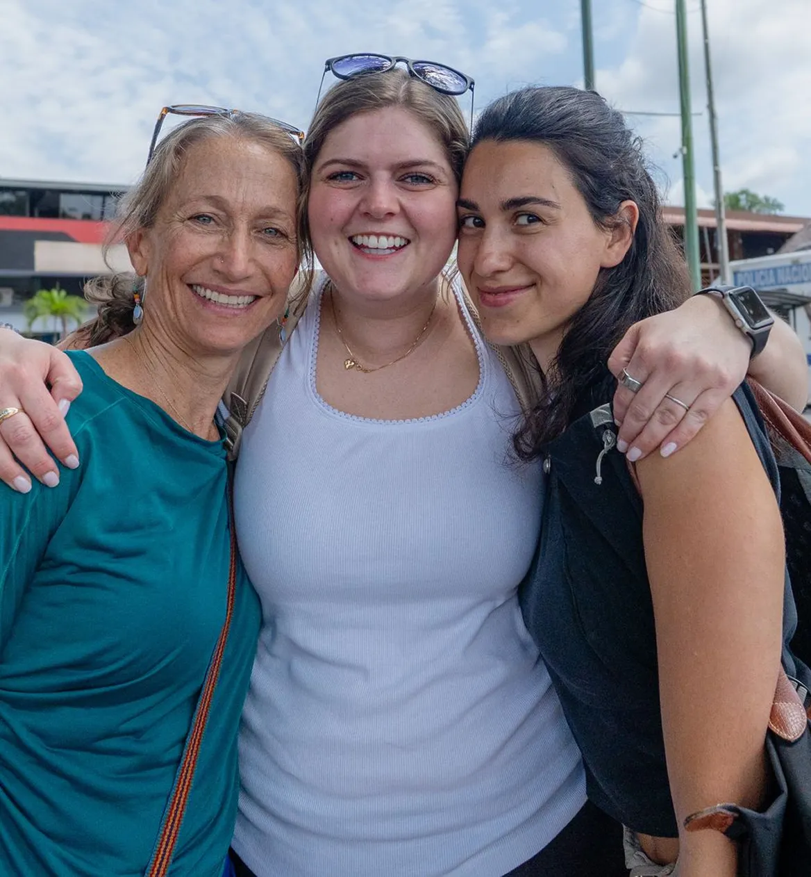Three women smiling together during an Unlimited Life retreat