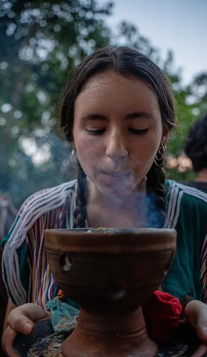 Woman holding a singing bowl during a breathwork and meditation session