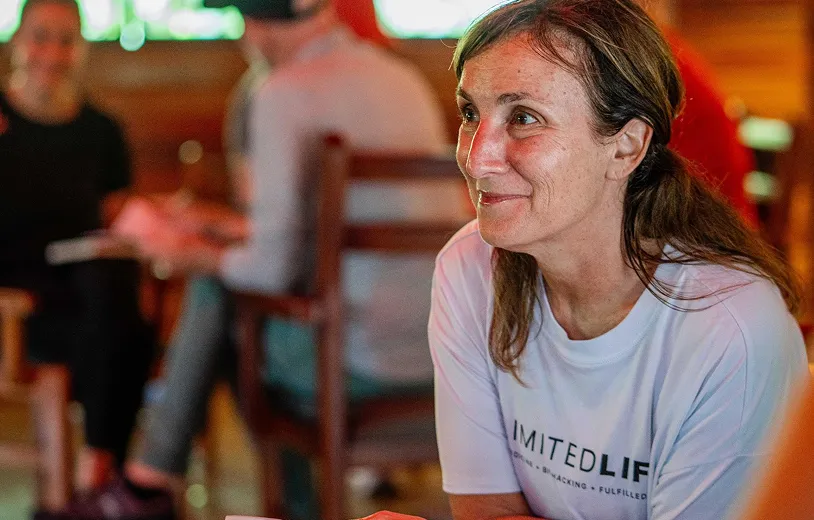 A group of community members gathered together, smiling and connecting
