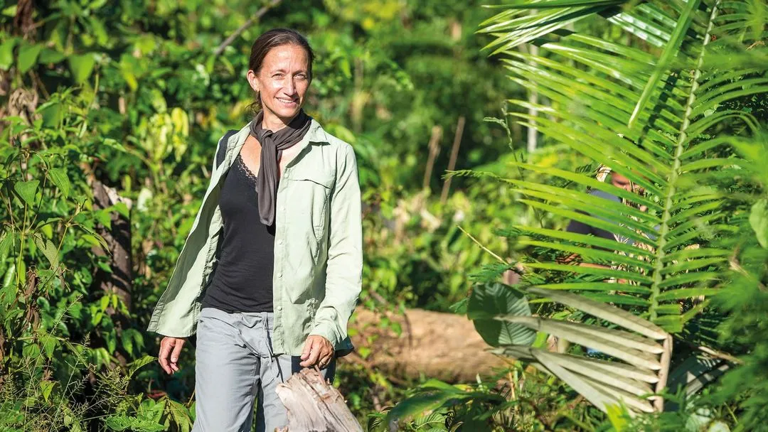 Celine Cousteau standing in the Amazon rainforest surrounded by tropical plants