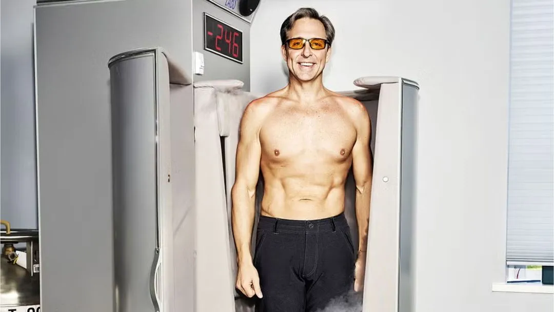 Dave Asprey standing shirtless next to biohacking equipment