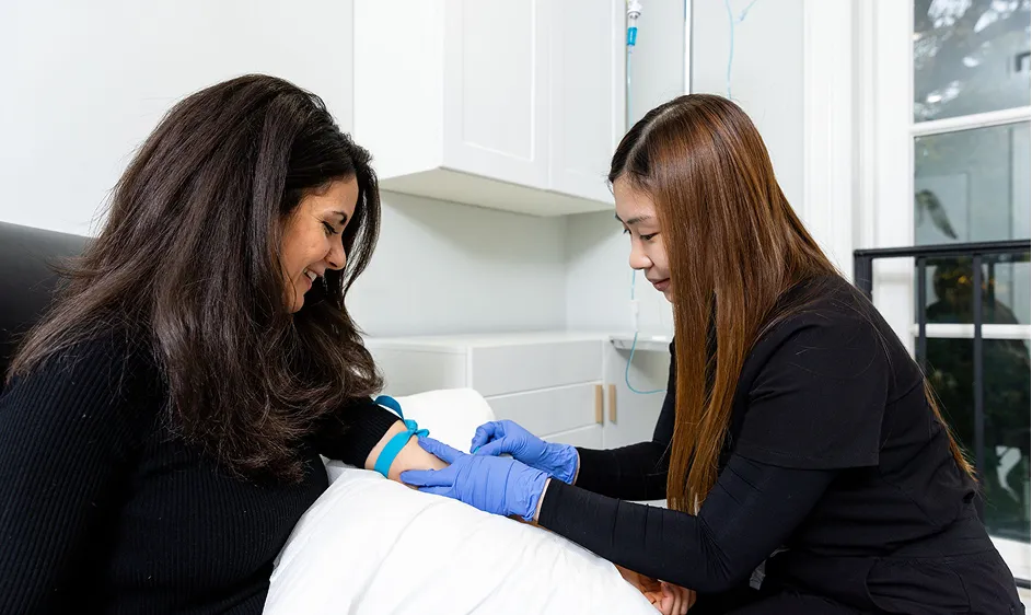 Nurse drawing blood from a patient during a medical test