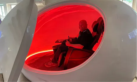 Group meditation session inside a modern glass wellness studio