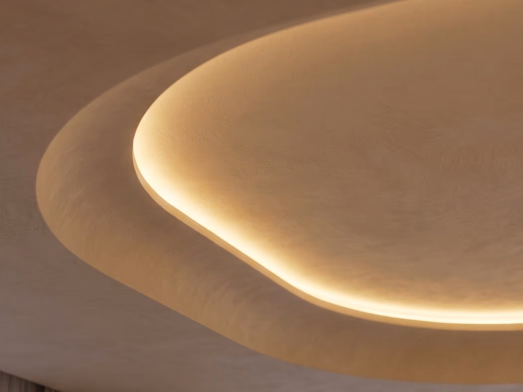 Curved ceiling cove with warm, indirect LED lighting creating a soft glow.