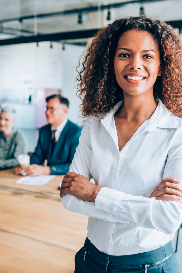 Smiling woman leading group session in conference room