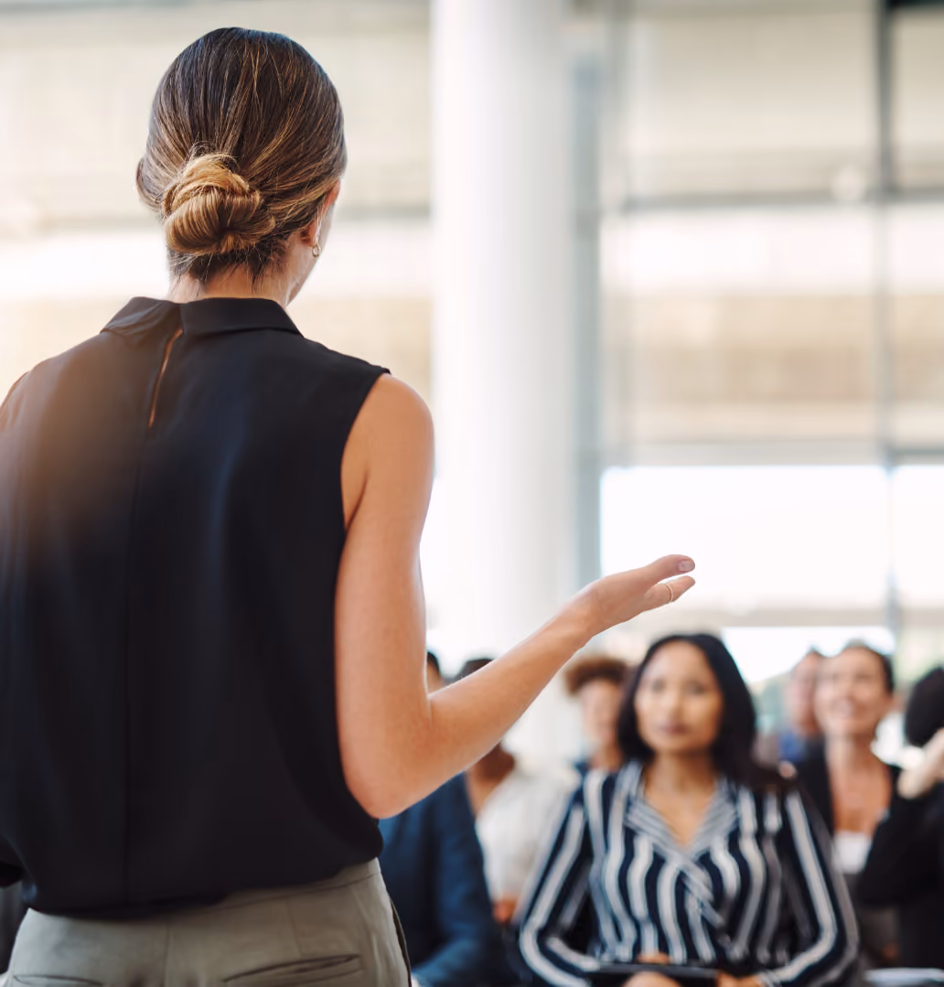 Woman speaking in front of professional crowd