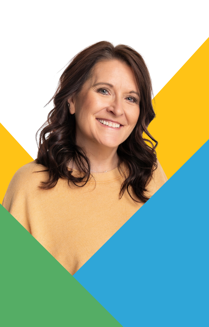 Smiling woman with dark wavy hair in a light yellow sweater against a color-block background.
