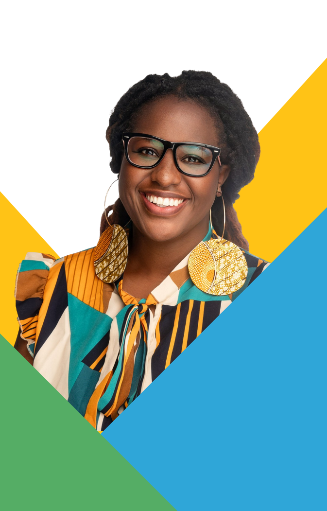 Smiling woman with glasses, large round earrings, and a colorful patterned blouse.