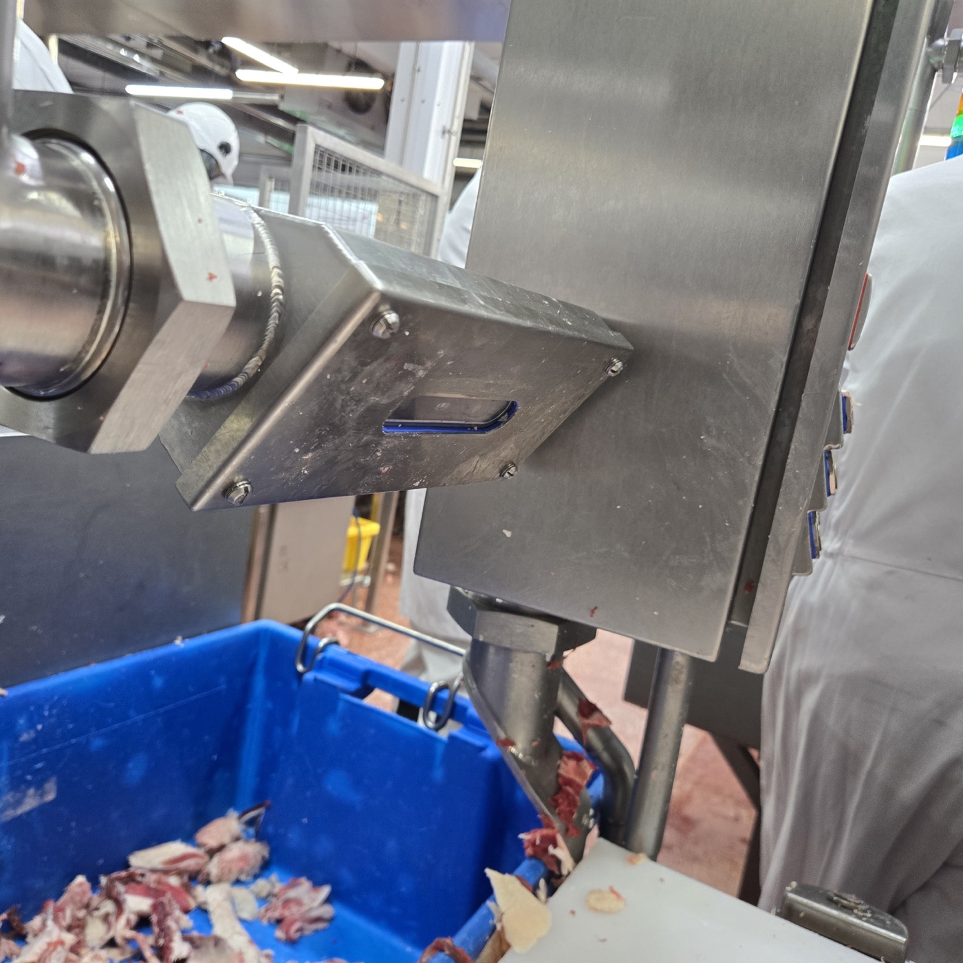 A FloVision sensor unit mounted on an existing grinder discharge over a product bin