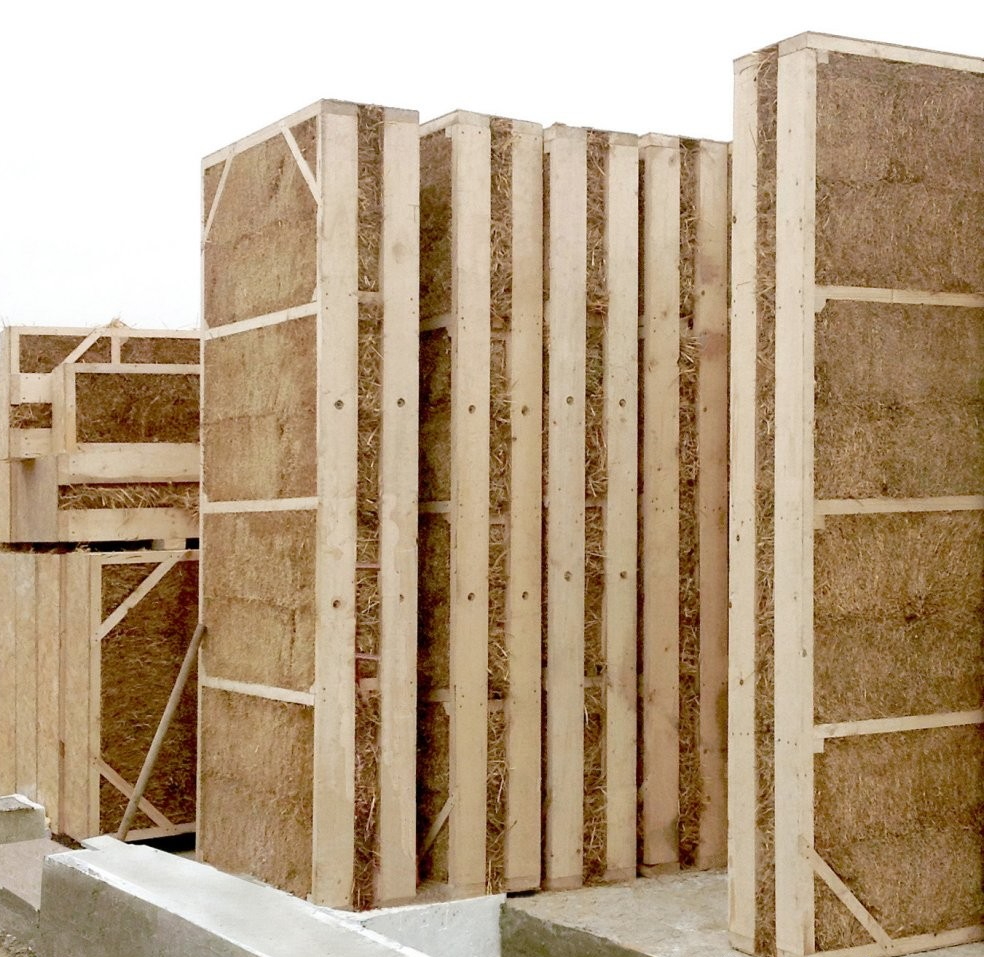 Finished Eco-Bud straw panels standing on the foundation