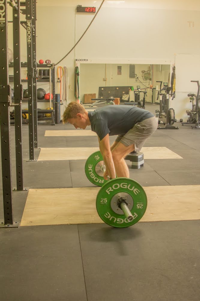 image of a personal trainer guiding a client through a workout