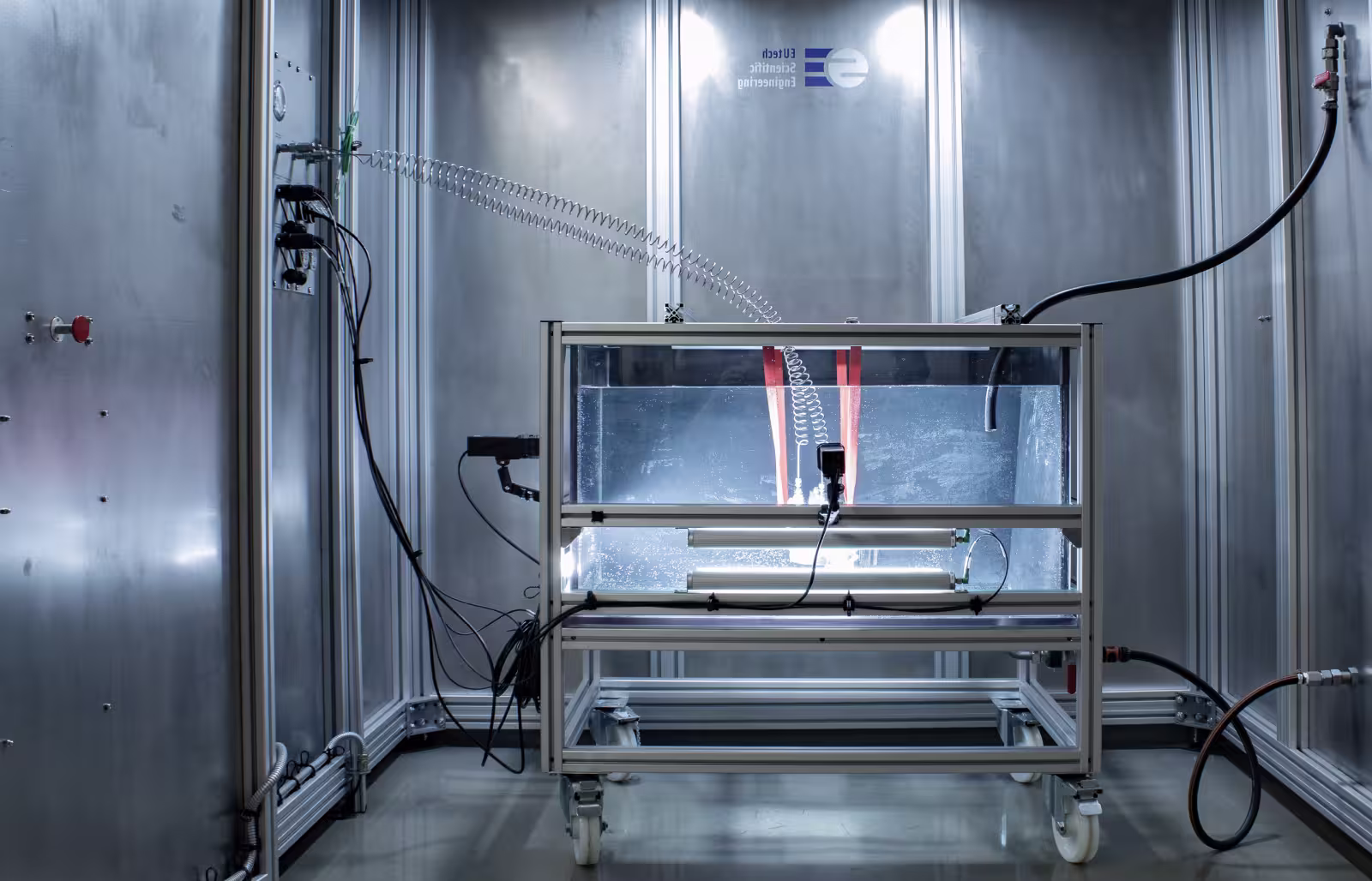 Leakage test setup with cables and indicator lights in a clean industrial laboratory.