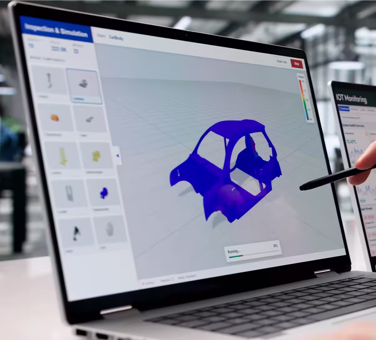Laptop screen displaying a 3D model of a car frame in blue with simulation options on the side.