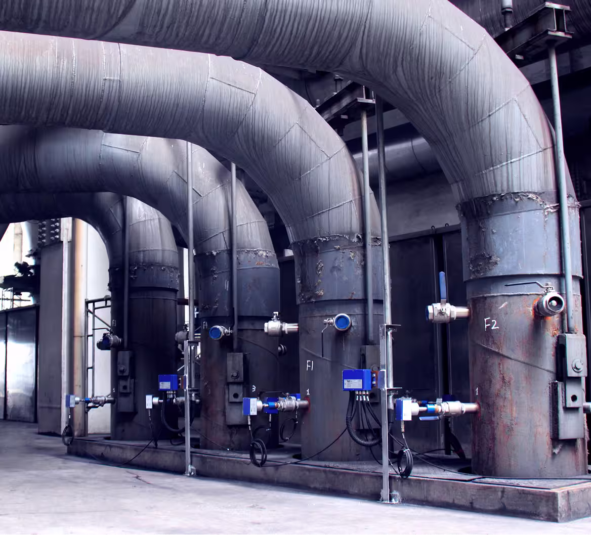 Large industrial pipes and valves equipped with EUtech diagnostic systems in a power plant setting.