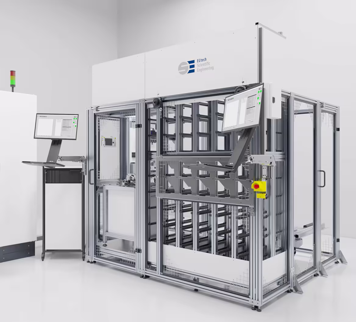 System automation setup for tile handling with a safety enclosure and dual-monitor control station.
