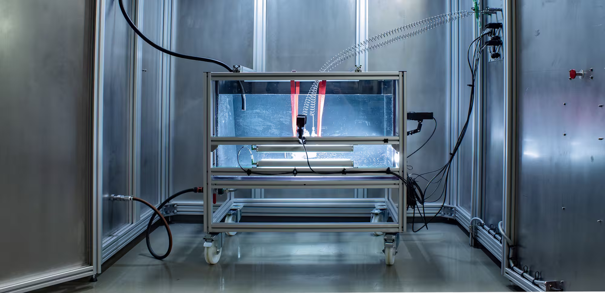 Leakage test setup with cables and indicator lights in a clean industrial laboratory.
